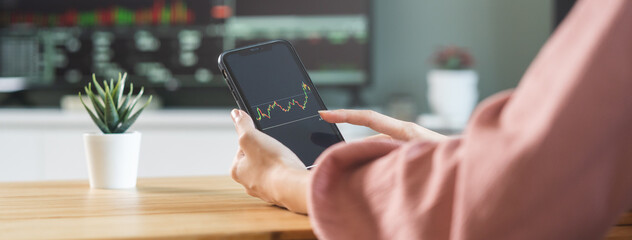Investor analyzing exchange market, asian young business woman, girl trader on graphic charts on tablet, smartphone for trading stock, looking at screen with diagrams at home office. Start up people.