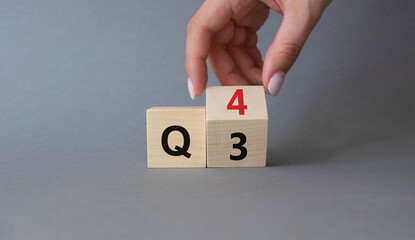 From 3rd Quarter to 4th symbol. Businessman hand Turnes cube and changes words 3rd Quarter to 4th...