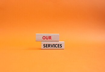 Our services symbol. Concept words Our services on wooden blocks. Beautiful orange background. Business and Our services concept. Copy space.