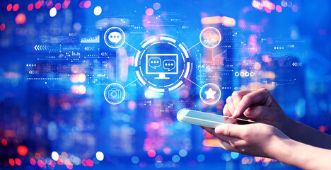 Social media theme with person using a smartphone in a city at night