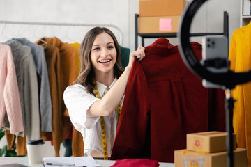 Beautiful girl clothing designer, the owner of the shop, she is the owner of a female fashion clothing store and designs clothes and cutting sets, selling products through online and live websites.