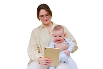 Happy woman mother with infant baby watching in digital tablet while sitting on home sofa in living room, isolated on a white background. Kid aged six months