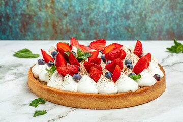 Sweet Cheese cakes tart pie with fresh berries on a light background. Top view