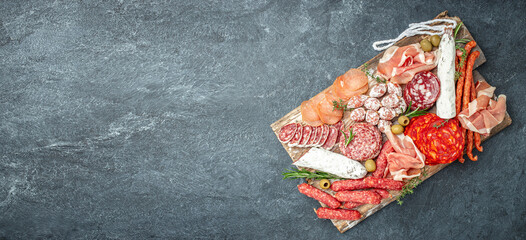 Italian meat platter prosciutto ham, salami, aperitivo party concept. Long banner format. top view - obrazy, fototapety, plakaty
