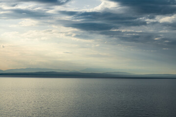 Fototapeta na wymiar Adriatic sea and island of Krk on horizon seen from the town of Lovran in Croatia