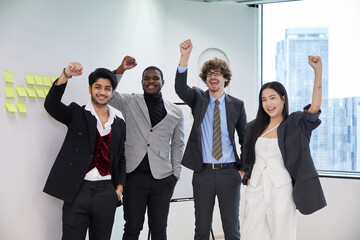 businesspeople raise arms up and celebrating success at work in the office