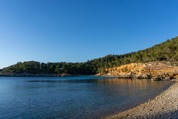 Fototapeta na wymiar Cala Salada, on the island of Ibiza, with the turquoise beach, without people on a sunny day.