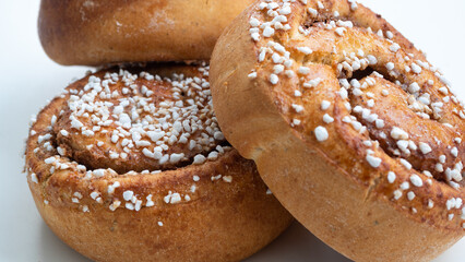 Three isolated cinnamon buns on white background. 