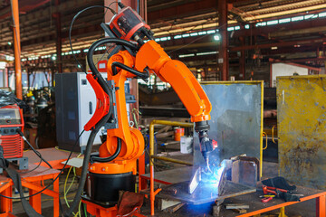 Robotic Welding Machine, Welding a Steel Plate of Steel Structure with Robotic Welding or Robotic Arm Welding at Industrial Factory.
