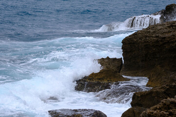 waves breaking on a Tuscan cliff
