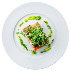 Appetizer puff eggplants with sweet peppers, cream cheese, arugula and pesto sauce.