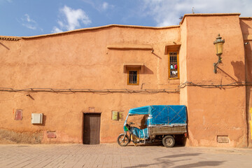 A tuk-tuk in Marrakesh outside a building