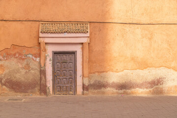 The outside of an old door and facade in the medina of Marrakesh, Morocco