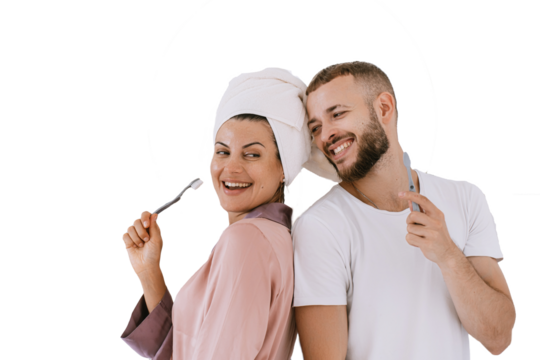 Cheerful caucasian young couple at bathroom brushing teeth toothy smiling cuddling. Newlyweds enjoying honeymoon against transparent background. hispanic girl with towel on head, fun with boyfriend.
