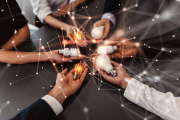 Fototapeta premium Teamwork and brainstorming concept with businessmen that share an idea with a lamp