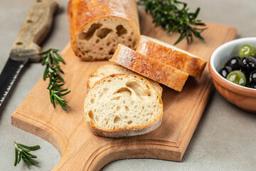 Italian ciabatta bread cut in slices on a light background. banner, menu, recipe place for text, top view
