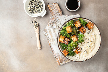 Vegan tofu poke bowl with rice and broccoli on a light background. Clean eating, dieting, vegan food concept. top view