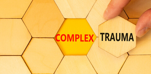 Complex trauma symbol. Concept words Complex trauma on wooden puzzles. Beautiful yellow table...