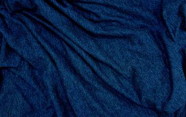 close up ripple blue fabric cloth background texture. crumpled luxurious blue fabric background and texture. abstract sensual background, empty template. selective focus.