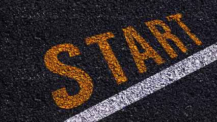 Start text written and line on the road in middle of the asphalt road, Start word on street.