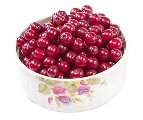 Bowl with ripe cherries. Isolated on a white background.
