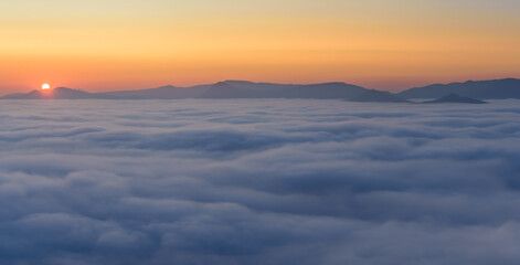 Cloud inversion above the CHKO Ceske Stredohori in Czechia during autumn sunset.