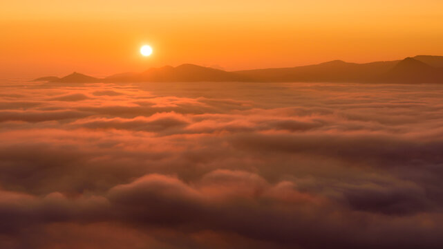 Cloud inversion above the CHKO Ceske Stredohori in Czechia during autumn sunset.