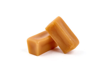 Caramel candies with caramel sauce, isolated on white background.