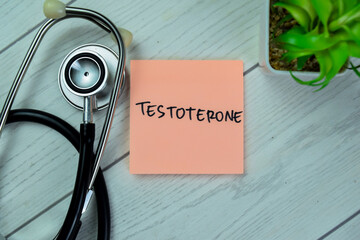 Concept of Testoterone write on sticky notes with stethoscope isolated on Wooden Table.