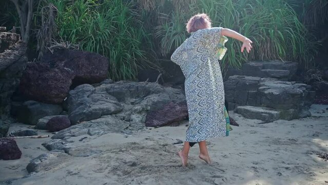 A woman dances against the background of nature,causing admiration for the dance