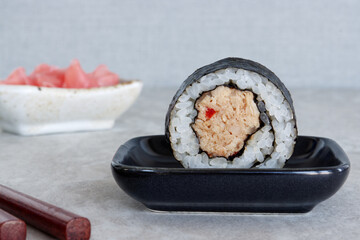 Homemade futomaki maki sushi roll with tuna fish paste. Table spin.