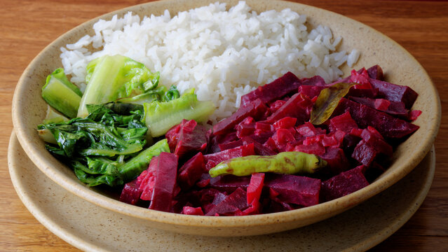 Beetroot curry with sona masoori rice and stir-fried lettuce. Asian cuisine.