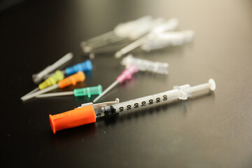 flu vaccine and needle syringes showing opioid crisis needle therapy and virus