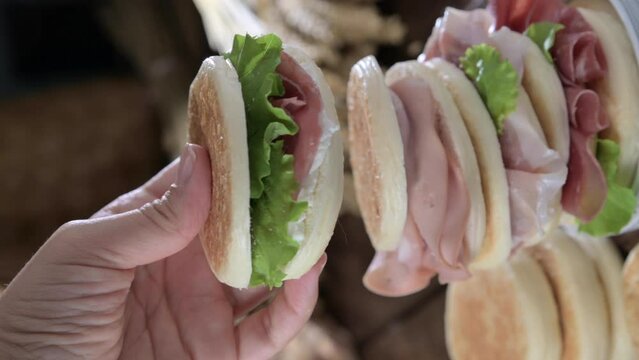 tigelle or crescentine homemade, con prosciutto, salame, stracciatella liquida. Italian food typical of the area of Modena, Emilia-Romagna. Thin round breads stuffed with prosciutto. 4k footage