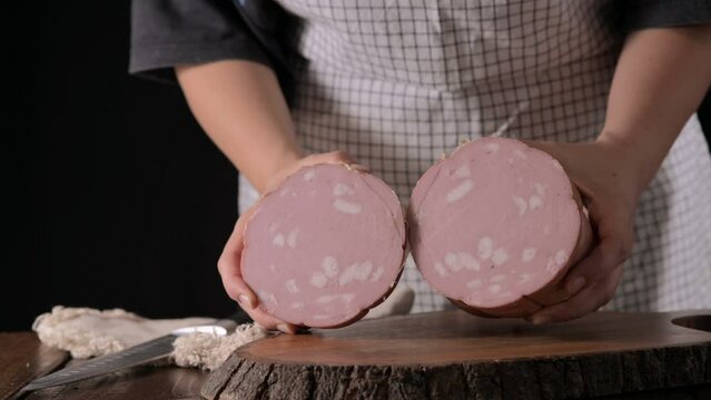 Mortadella. Traditional pork sausage with pistachios or black pepper. Italian delicacy from Bologna. High quality 4k footage