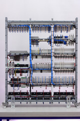 Connection of blocks and modules with an insulated wire on the reverse side of the electrical switchboard. Fastening with plastic mounting ties.