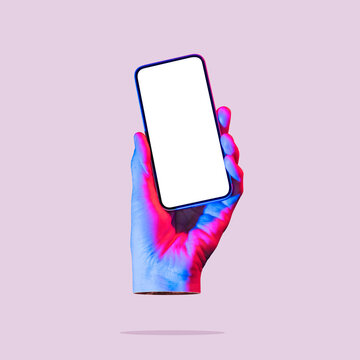 The hand holds a smartphone with a white screen. Art collage. Mockup.