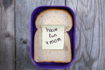 A purple lunch box with a sweet note for the day
