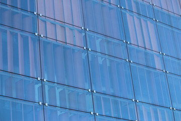 Abstract image of a new building facade of a glass panels. Behind the glass panels are shutters for sun protection.
