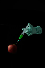 Injection of poison into a genetically modified apple