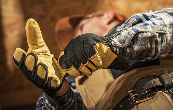 Professional Contractor Putting on Construction Gloves