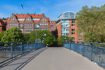 Cityscape of Bremen with old architecture, historical wooden sailing ships and barge floating along the river Weser. Bremen, Germany, July 15, 2021