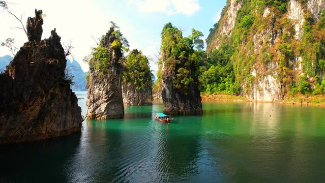 Bird's eye view of "Khao Sam Kloe" in Thailand through the eyes of a drone, showcasing its lush forests, lake and panoramic views. (Khao Sok National Park in Surat Thani Province, Southern Thailand).
