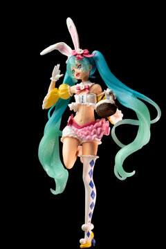Russia, St. Petersburg, February 2023: Bunny, Easter bunny Hatsune Miku figurine with a basket on a black background