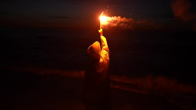 a lonely traveler in distress, shipwreck victim signal light at night help signal ocean at night