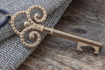 A top view image of a vintage key on canvas and wood