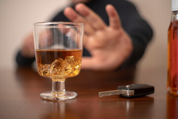 Cropped image of man showing stop gesture and refusing to drink