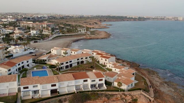 Drone point of view of coastal houses in the Playa Flamenca. Costa Blanca. Province of Alicante. Spain. Travel and tourism concept