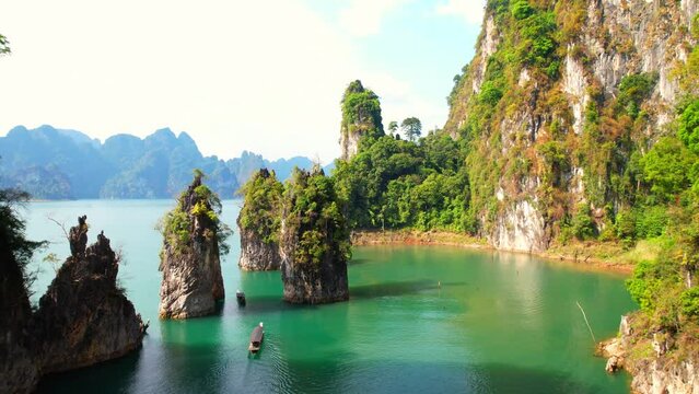 Breathtaking drone of "Khao Sam Kloe" in Thailand, a hidden gem waiting to be explored. Admire the panoramic views of lake, limestone cliffs, and lush forests in this picturesque destination.

