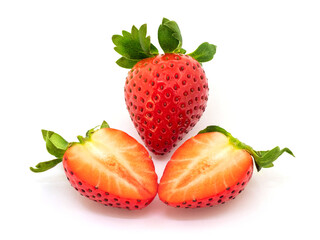 A whole strawberry and a strawberry cut in half on a white background isolated. Appetizing strawberries